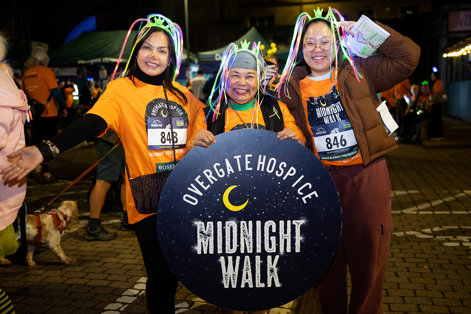 Walkers with the Overgate Hospice Midnight Walk sign